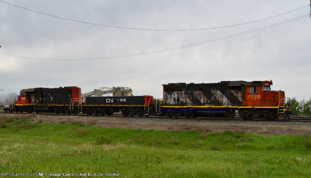 CN 7526/526/7503 pulling a string of mixed freight tank cars, covered hoppers and Autoracks W/B out of the Cloverbar Yard